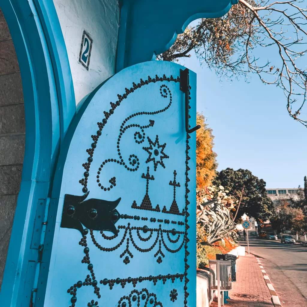 a blue Tunisian door in Sidi Bou Said, Tunisia with black geometric patterns