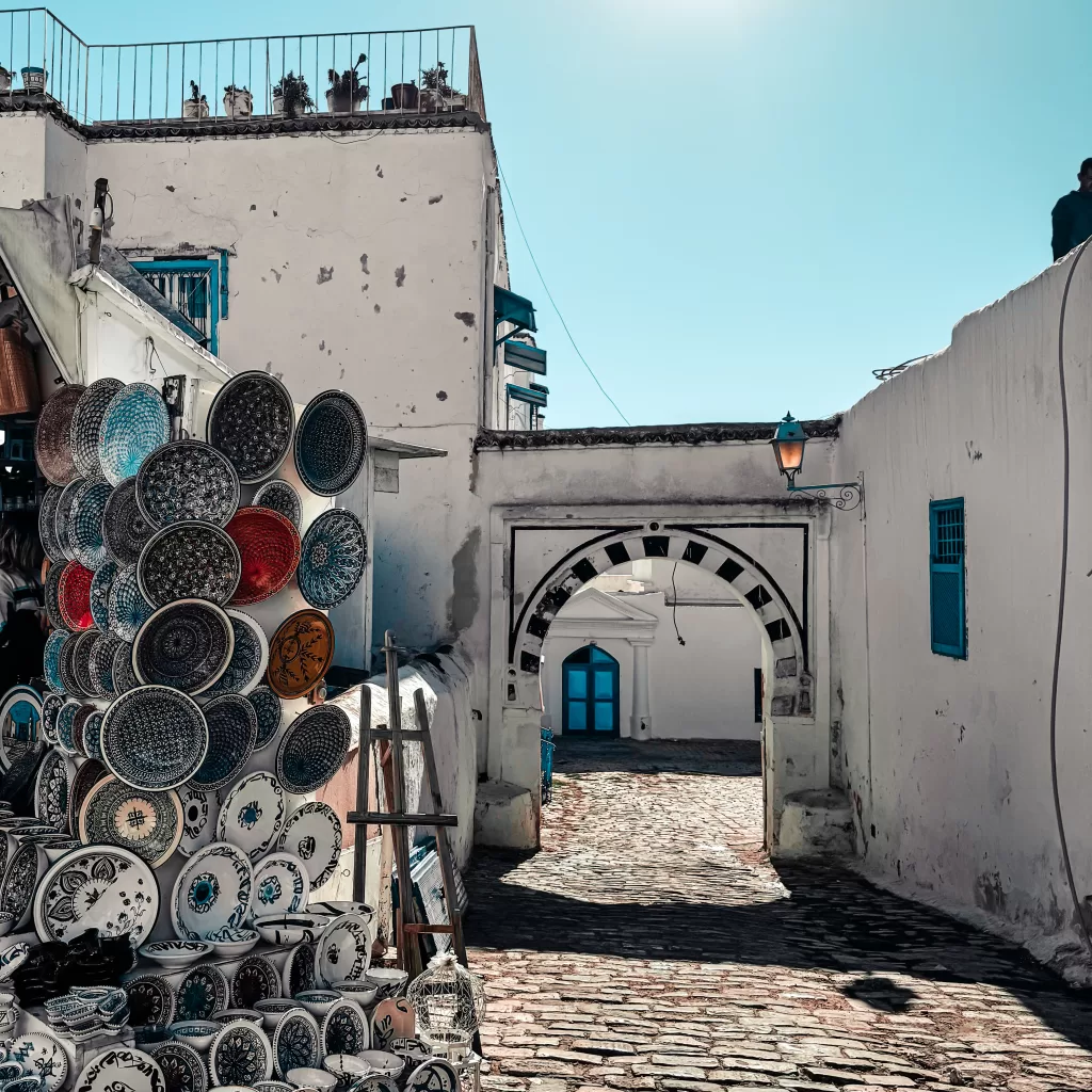A white and blue street in Tunisian Santroini, Sidi Bou Said with ceramic artwork
