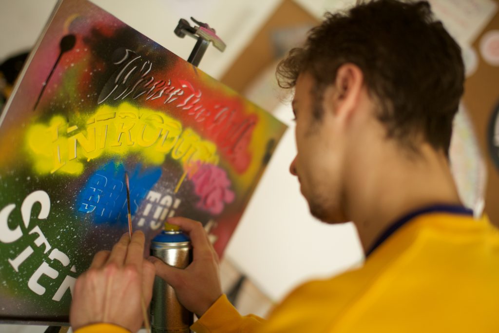 Teenage boy doing spray art workshop. Credit: Where The Wall.
